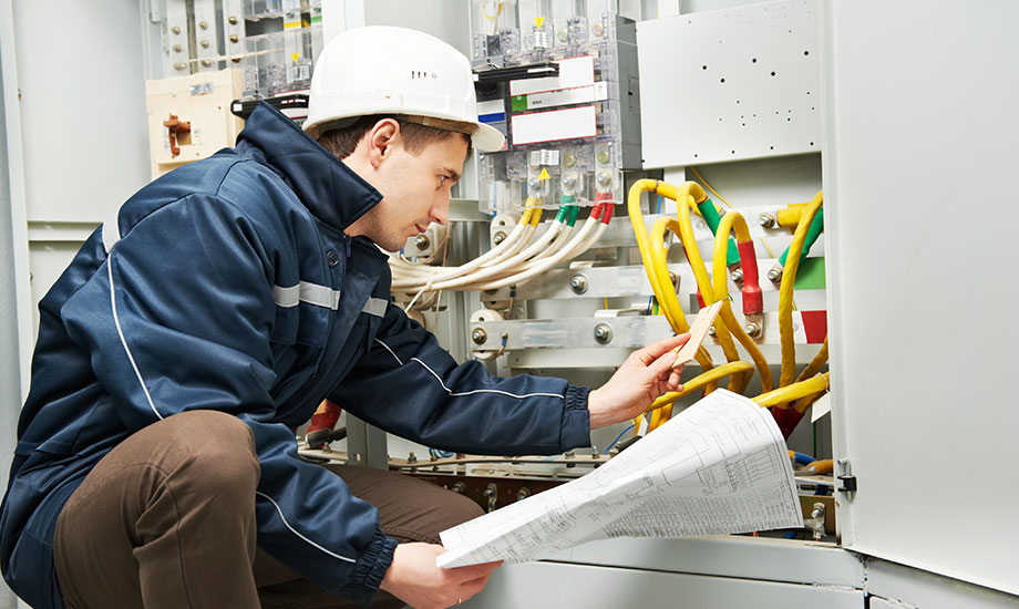 electrician inspecting cabling of high voltage