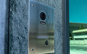 intercom at the door of a building with security camera